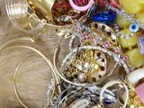 a pile of jewelry sitting on a wooden table