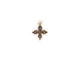 un pendentif en forme de croix en or, orné de diamants noirs sur fond blanc