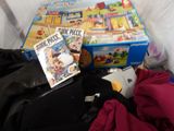 a pile of toys and books on a bed