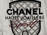 a white t - shirt with a chanel logo on it