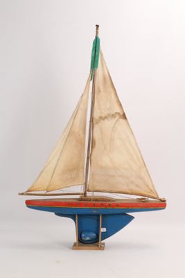 a small wooden sailboat with a sail on it