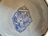 a blue and white bowl with a picture of a lion on it