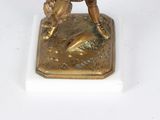 bronze figurine of a baseball player on a base with a bat