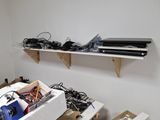 a laptop computer sitting on a shelf in a room