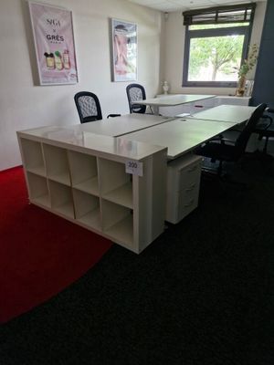 un bureau blanc avec une chaise noire et un tapis rouge