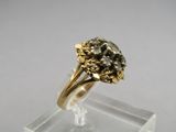 an image of a gold and diamond ring on a clear stand