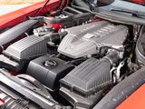 the engine of a red car with its hood open