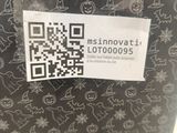 a sticker on the back of a suitcase that has a qr code on it