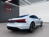 the rear end of a white audi sports car in a showroom