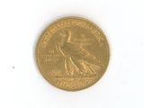 a gold coin with a bird on it on a white surface