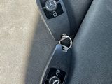 two car keys sitting on the back seat of a car