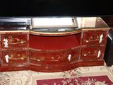a large television on a stand with a glass top