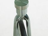 a black pen sitting inside of a glass bottle on a table