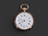 a close up of a gold pocket watch with roman numerals and roman numerals