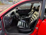 a red car with black leather seats in the back of it