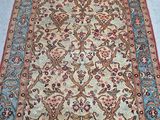 an antique persian rug with a floral design on a blue ground
