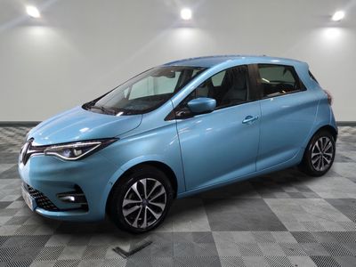 a blue car is parked in a room with a checkered floor