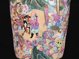a vase with a painting on it sitting on a table