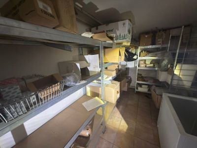 a room filled with boxes and shelves with boxes on them
