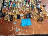 many bottles of perfume sitting on a table with a price tag