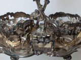 a silver tray that has a bunch of silver items on it