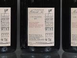 three bottles of wine are lined up on a table