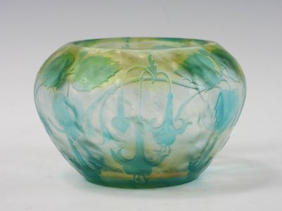 a glass vase that is sitting on a white surface