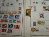 an open book with stamps and stamps on it on a table