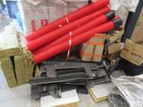 a pile of red fire extinguisors sitting on a table