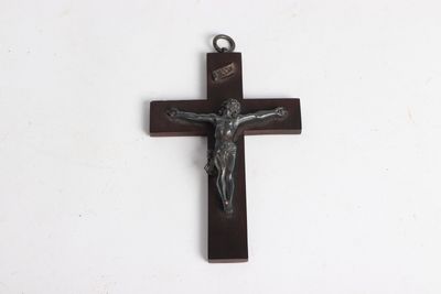 a close up of a cross on a white surface with a white background