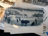a bunch of old postcards that are on a table