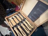 a wooden box with a set of knives inside of it