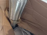 a metal pipe sticking out of a cardboard box