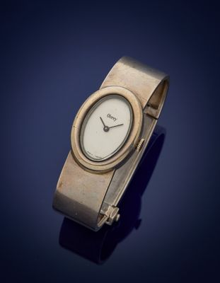 a close up of a wrist watch on a blue surface