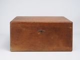 an old wooden box sitting on top of a white surface
