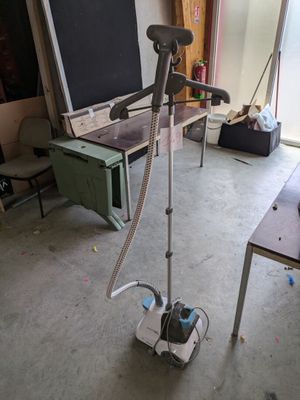 a computer on a stand in the middle of a room