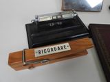 a small wooden box with a name plate on it
