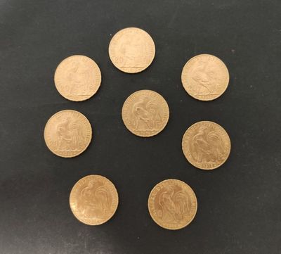 un groupe de six pièces d'or posées sur une surface noire