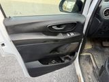 a car door open with the driver ' s seat down