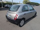 a silver car that is parked in a parking lot