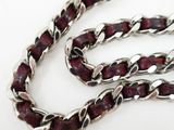 a close up of a silver chain with red beads on a white background