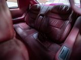 a red car with leather seats in the back of it