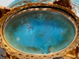 a blue and gold vase sitting on a table
