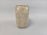 a vase that is sitting on a white surface