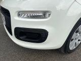 a small white car parked in a parking lot