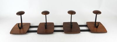 three wooden birds are perched on a metal stand on a white background