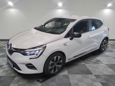 the white car is parked on a checkered floor in a garage