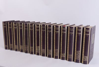 six books are lined up in a row on a white surface