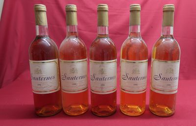 six bottles of wine are lined up in a row on a pink background