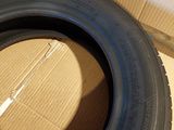 a close up of a tire on a cardboard box on a floor